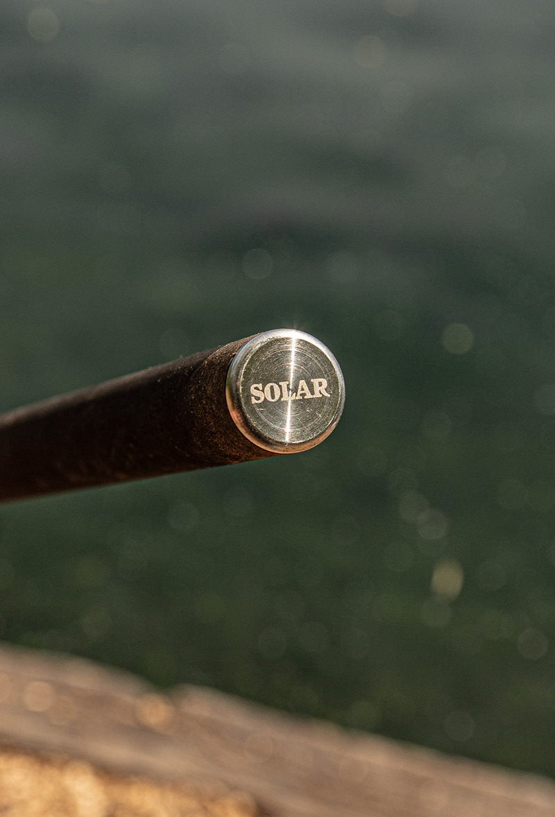 Laser-etched stainless butt cap on the carbon handle of the Solar Bow-Lite landing net