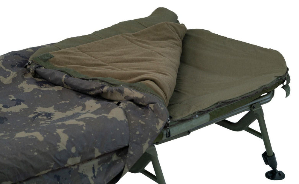 The modular bag opened at the corner to show the layers: camo outer, olive smooth face and a thick fleece layer folded back, plus the moulded crash zip. This is the reversible-laye