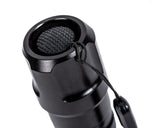 CarpLife Compact Bird Torch tail cap close-up showing the recessed rubber switch and wrist lanyard