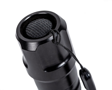 CarpLife Compact Bird Torch tail cap close-up showing the recessed rubber switch and wrist lanyard