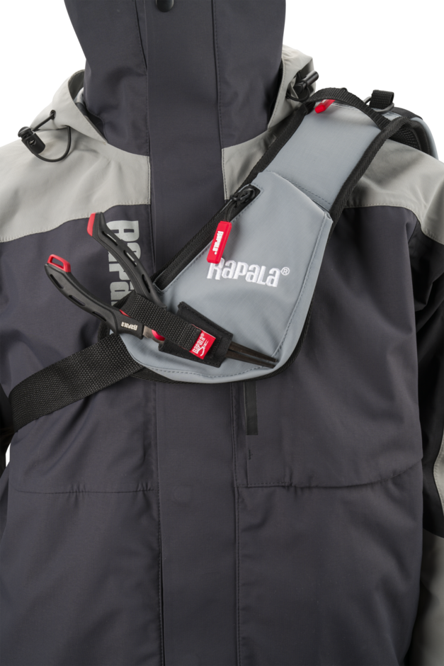 Close-up of the Rapala CountDown Sling Bag Pro padded sling strap worn across the chest, with the zipped strap pocket and tool retainers
