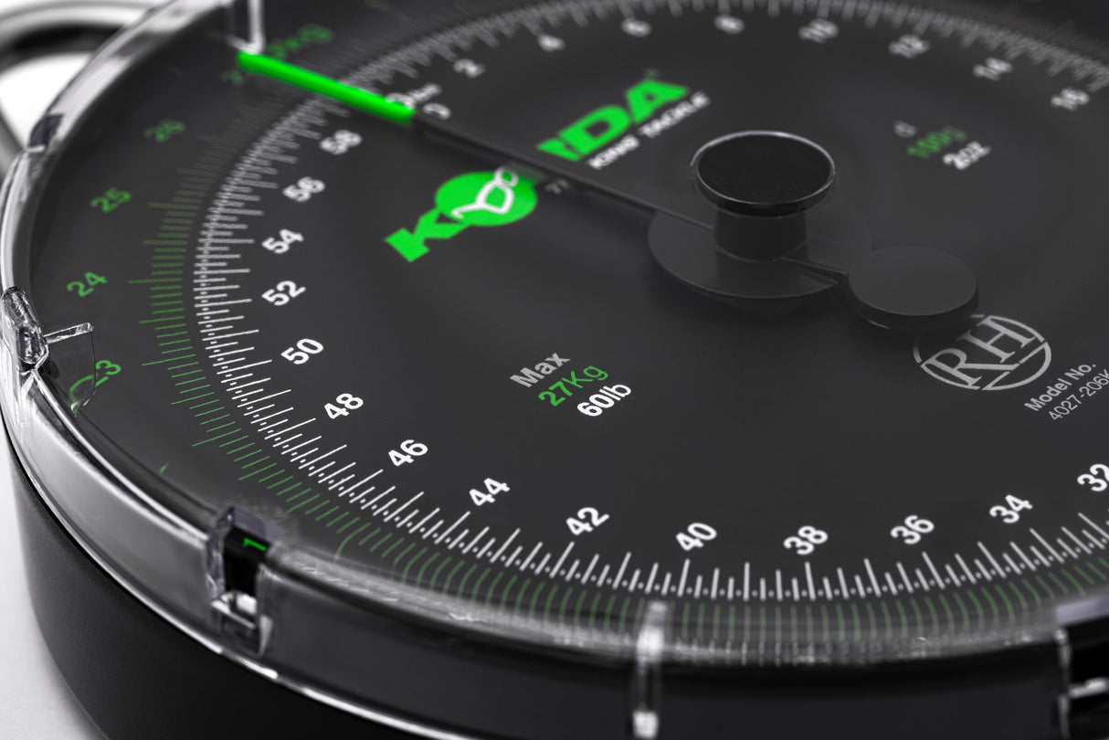 Angled close-up of the 60lb dial face, showing the green kilogram track, the white pound track and the Max 27Kg 60lb legend