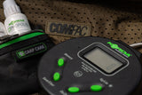 The digital scale resting on an unhooking mat beside a Korda carp care pouch and Propolis treatment bottle