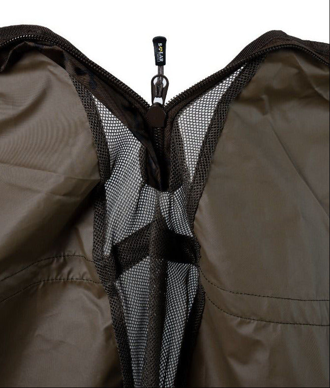 Interior close-up: the sling opened to show the quick-drain mesh panel running down the middle and the zip with a SOLAR TACKLE branded pull and its clip.