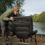 An angler setting the recline from behind. IDENTITY EVIDENCE: the back panel is embroidered 'WORLDWIDE COUCH CHAIR' in gold, so the product names itself in the photograph. Both rat